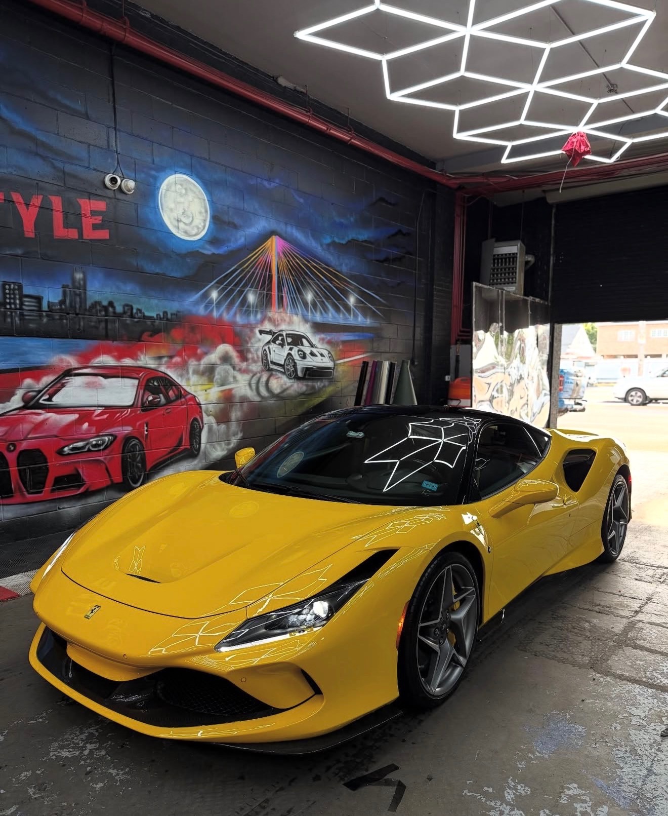 Yellow Ferrari F8 in the Lyfestyle Customz bay