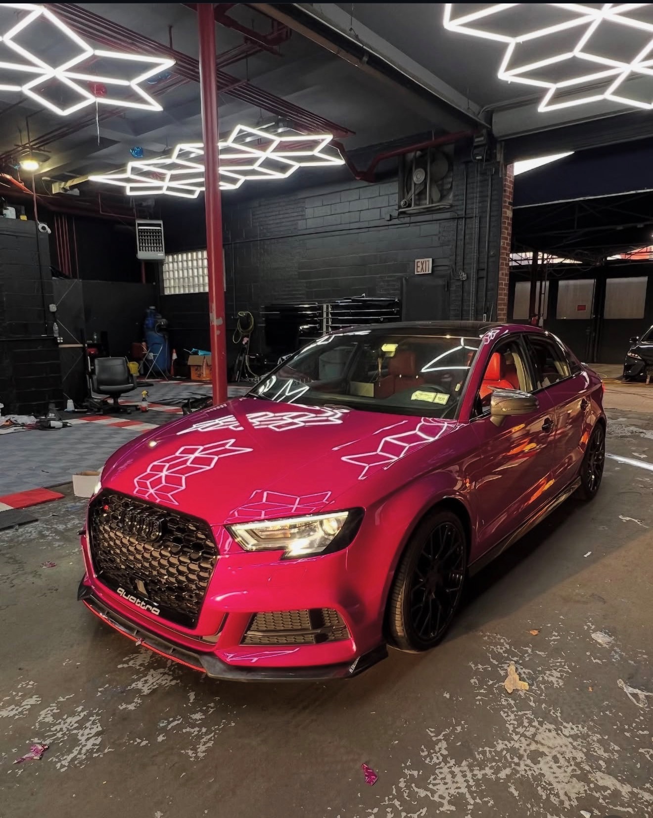 Magenta wrapped Audi RS3 under the hex lights in our shop