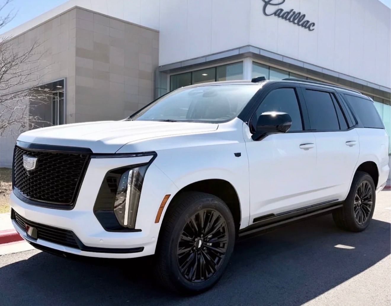White Cadillac Escalade with chrome delete and blacked out wheels